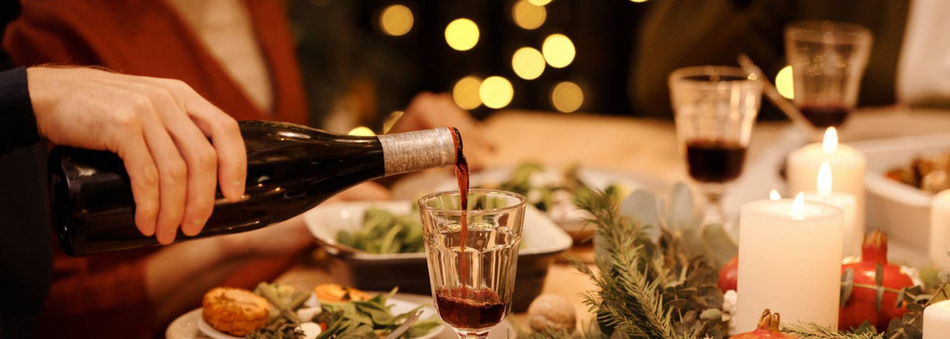 Personne qui verse du vin à une table de fête